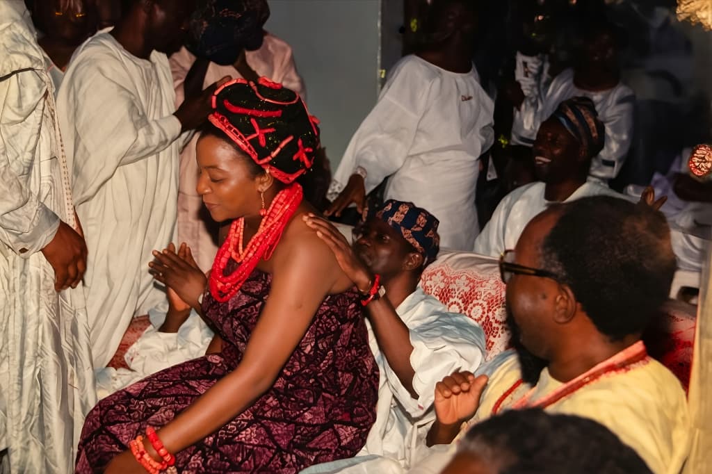 Chief (Arc.) Isaac Fola Alade receiving his daughter-in-law at the traditional marriage ceremony of his son Oladipo Fola Alade to Osarhieme Fola Alade.